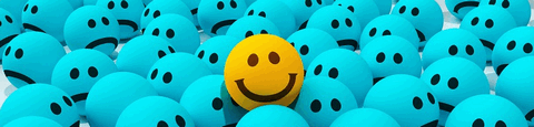 ein kleiner gelber Smiley inmitten vieler kleiner blauer Smileys